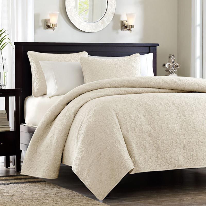 luxurious bedding with a cream quilt, pillows